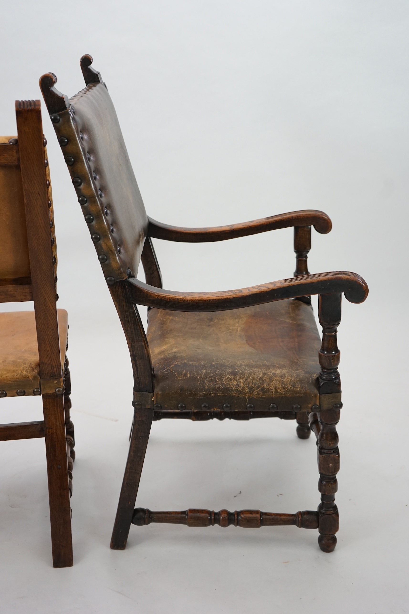 A set of fourteen 17th century style oak dining chairs including a pair of carvers